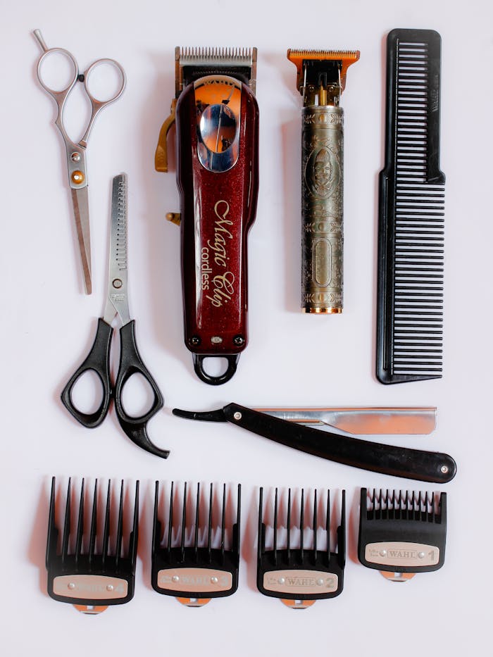 Collection of essential barber tools for precision haircuts, showcasing scissors, clippers, and combs.